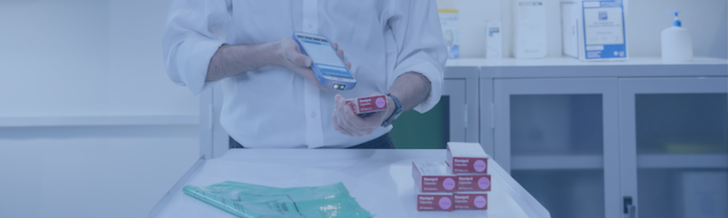 Technician in a lab scanning a package with a Zebra HC50. Photo has a blue overlay.