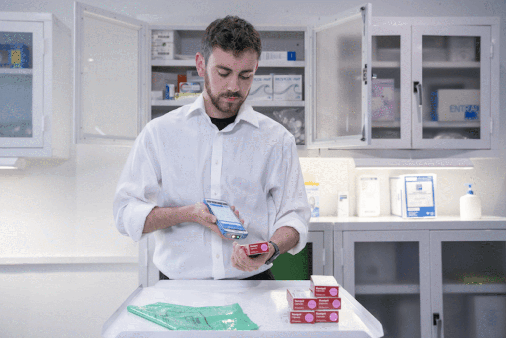 Technician in a lab scanning a package with a Zebra HC50